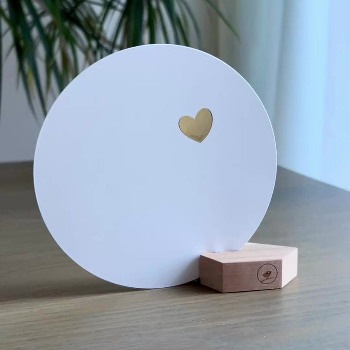 Witte ronde wenskaart in een houten kaartblokje met een klein gouden veel liefs hartje